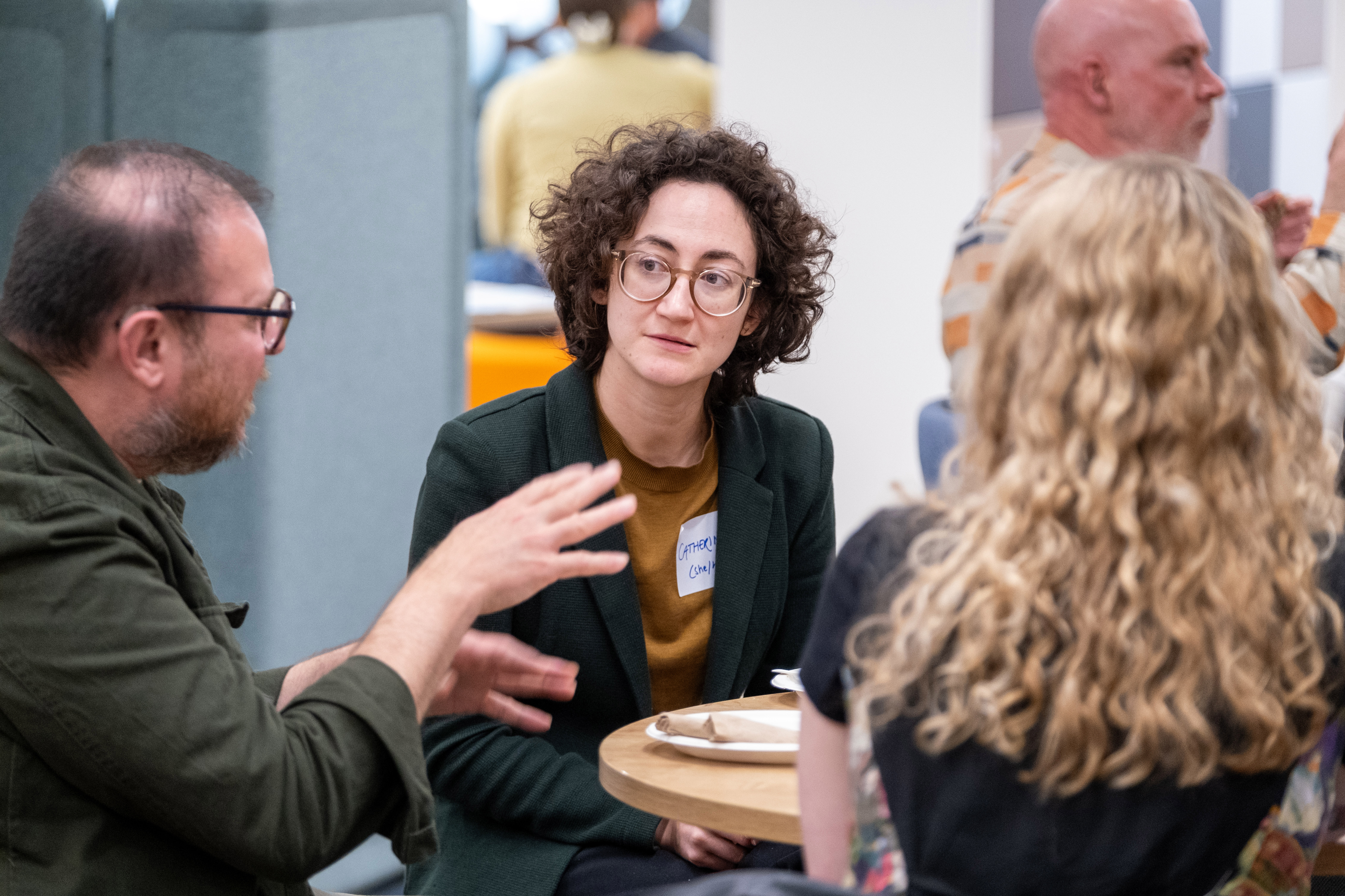 3 people chatting at a table