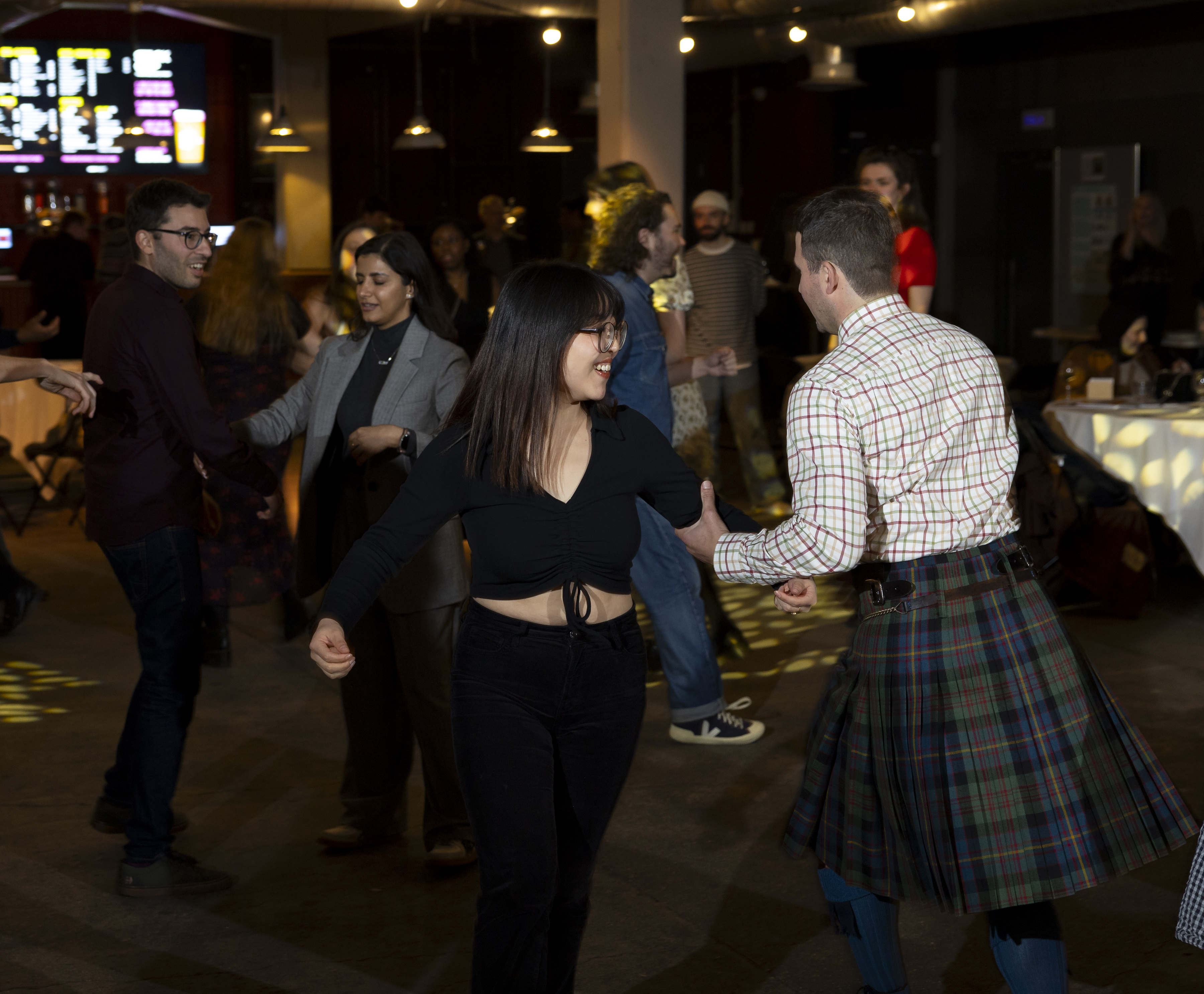 People swinging each other round at a ceilidh