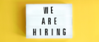 Lightbox with a words text We Are Hiring board on yellow background