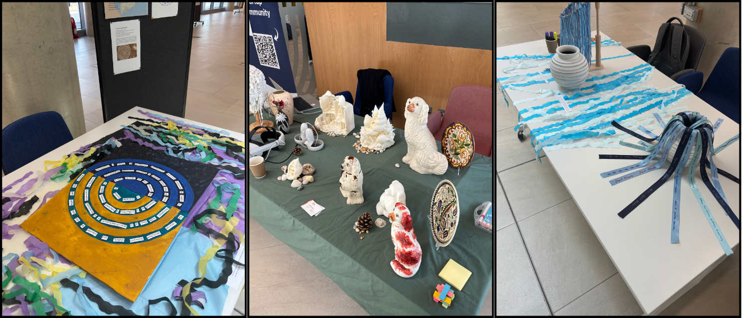 Three display tables at the SGSAH Research Showcase 2026 featuring creative research projects: a colourful spiral artwork with labelled sections, a collection of ceramic sculptures and decorative pieces, and an installation of blue paper streams and ribbons and earthenware pots arranged across a table.