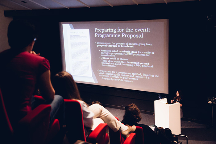 Lecturer gives lecture in lecture theatre